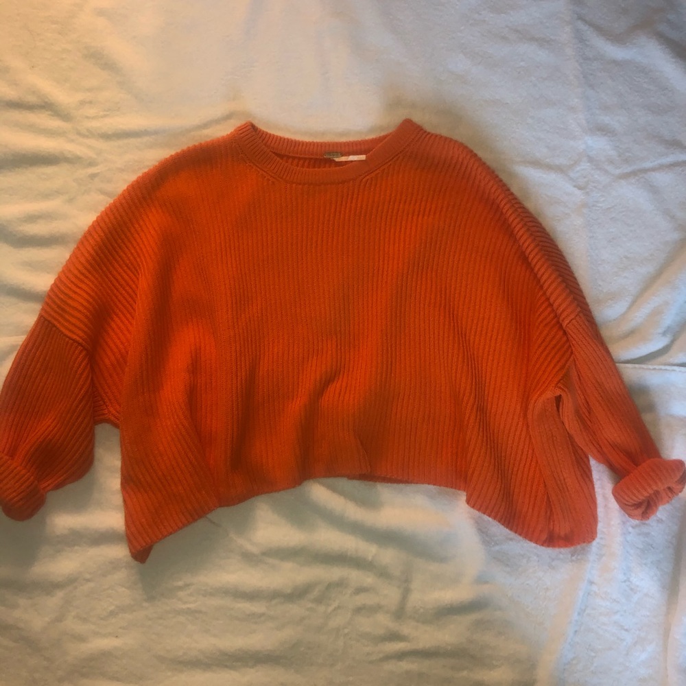 Cropped baggy orange sweater.